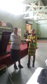 Clarice receiving her prize from the DR&SS Principal Director, Mrs Hikwa.